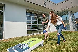 Employees playing corn hole at Orases 