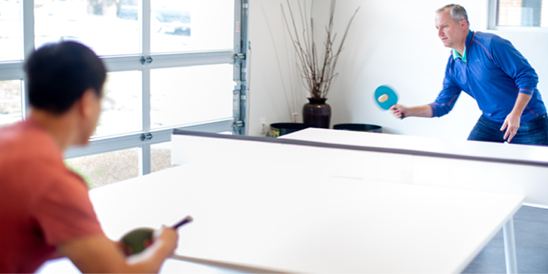 orases employees enjoying a break playing table tennis