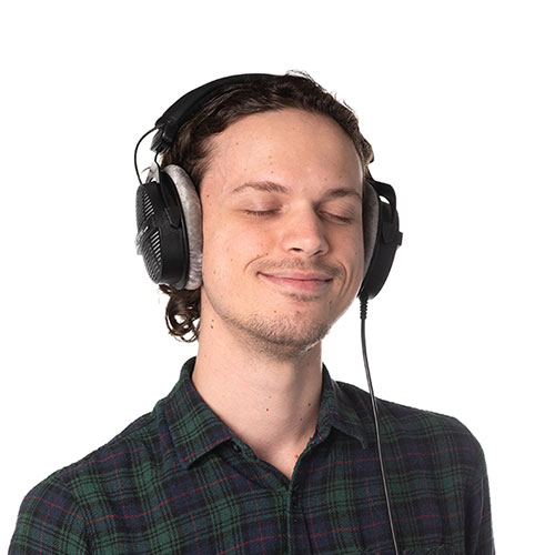luke butler team member at orases listening to music with his headphones
