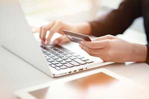 Woman paying her SaaS software monthly subscription