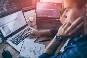 A programmer checking for code error. Java scripting language is mostly used in software development