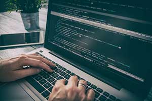 Developer using C language to program custom software