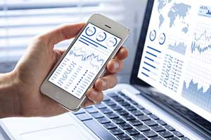 Man using his cross platform mobile application to view analytics