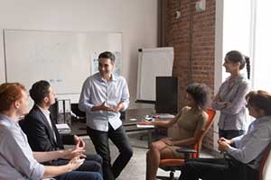 Employees at a cross department meeting