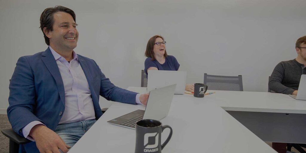 Nick and Orases employee reviewing a custom ERP software project