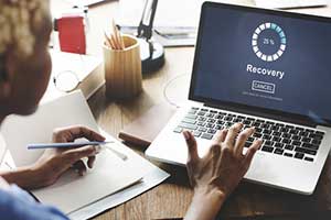 Woman recovering her lost data from the cloud