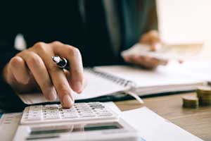Woman calculating costs of an off-the-shelf ERP software solution