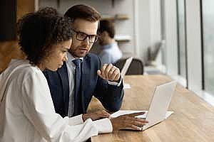 a web portal developer speaking with a business owner
