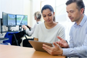 women and man looking at saas pricing model