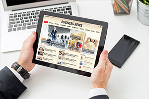 Man going through business news web portal