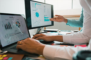 employees looking at different types of database migration methods