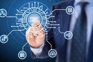 blue suit clicks on a circuit diagram with the words edge computing