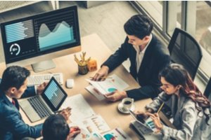 Employees during meeting comparing onshore and offshore software development services