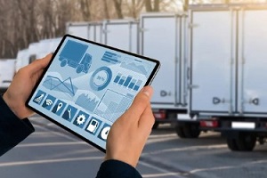person with tablet in hand with transportation management systems