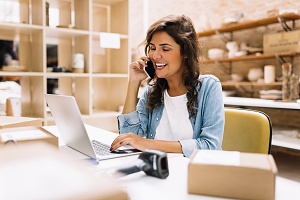 business woman scrolling through her laptop using wms for warehouse data