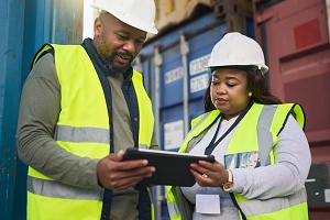 logistics technicians looking through data using a notepad