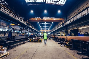 warehouse employee walking through the factory line