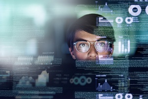 woman programmer looking at their code as they design software