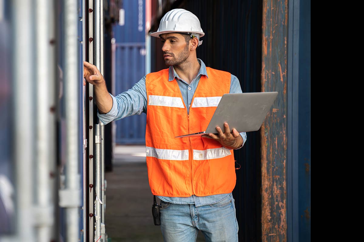 ship yard manager walking through the freight for inspection