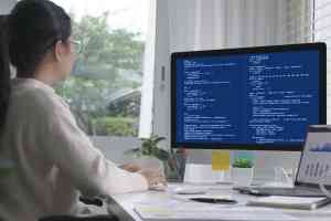 young woman organizing data sets at her computer