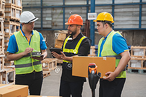 three supply chain managers going through their inventory