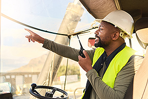 a freight manager pointing to his crew about where to take inventory