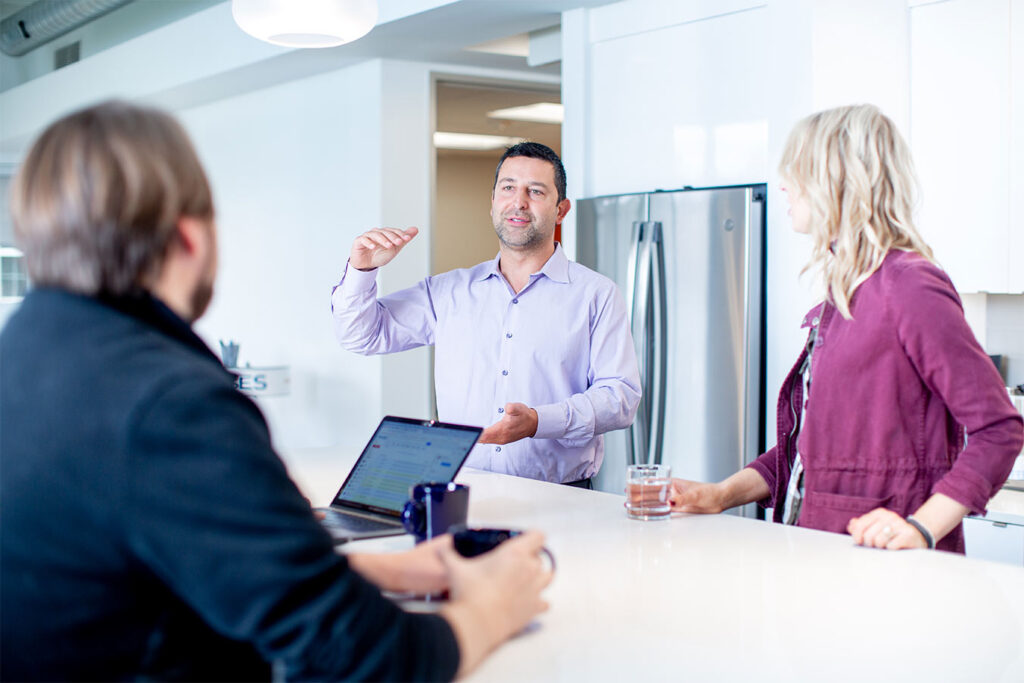 Orases CEO chatting with employees in office