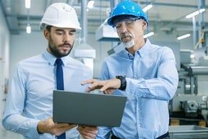 two manufacturing project managers discussing their plans