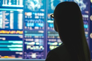 young business woman watching monitors over the performance of the internet of things