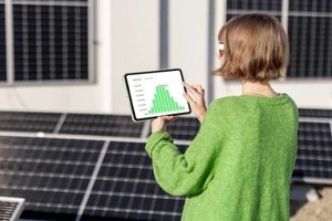 girl checking production scheduling software in solar panel factory