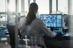 medical researcher looking at health data of a patient on a workstation