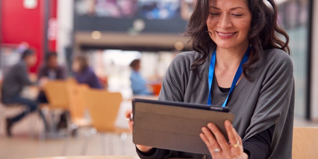 woman teacher using their tablet to navigate their elearning portal