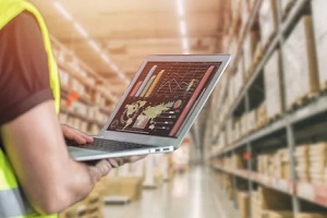 man with laptop in inventory