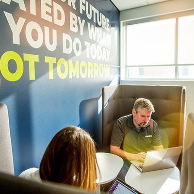 Orases team sitting across from each other discussing AI-Driven CRM Data Enrichment