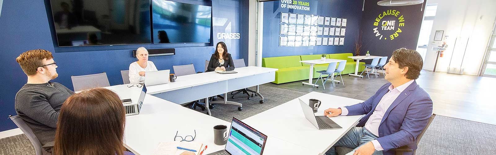 Orases team sitting at desk talking