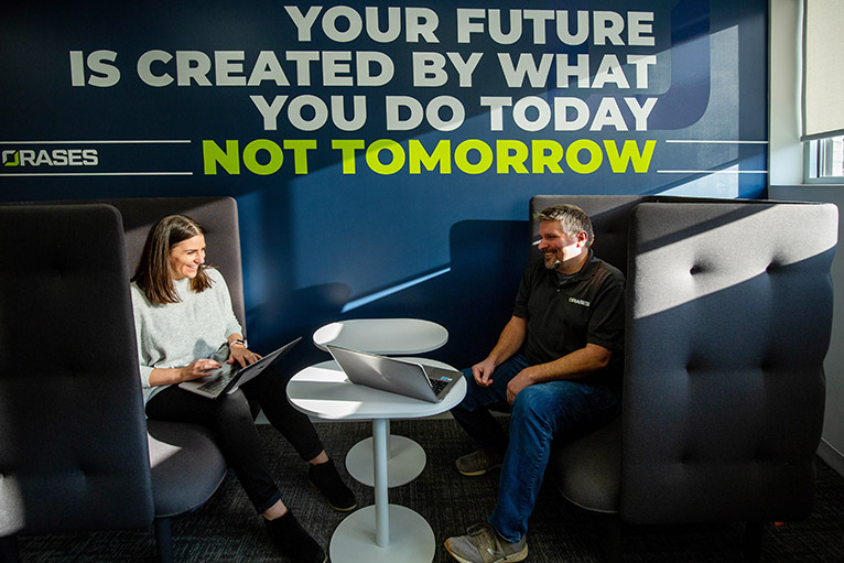 Orases team in office talking to each other