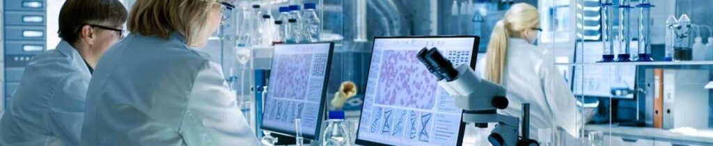 Lab workers reviewing data on a custom laboratory information management system