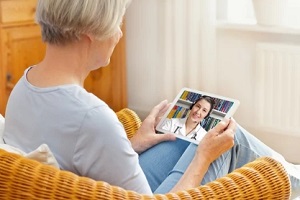 doctor giving online consultation to an old lady with telemedicine software