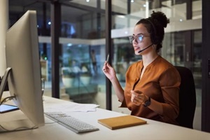 customer support and insurance agent consulting at night in a office at a contact help desk