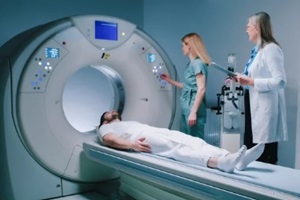 young man lies down in MRI capsule