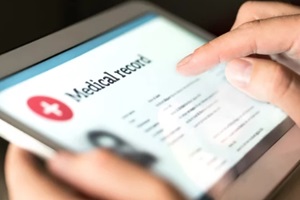 software for medical billing showing electronic medical record with patient data and health care information in tablet
