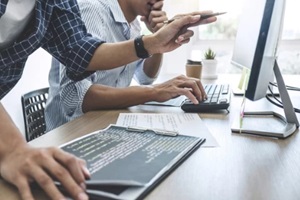 two professional programmers cooperating at developing programming and website working in a custom software develop company office