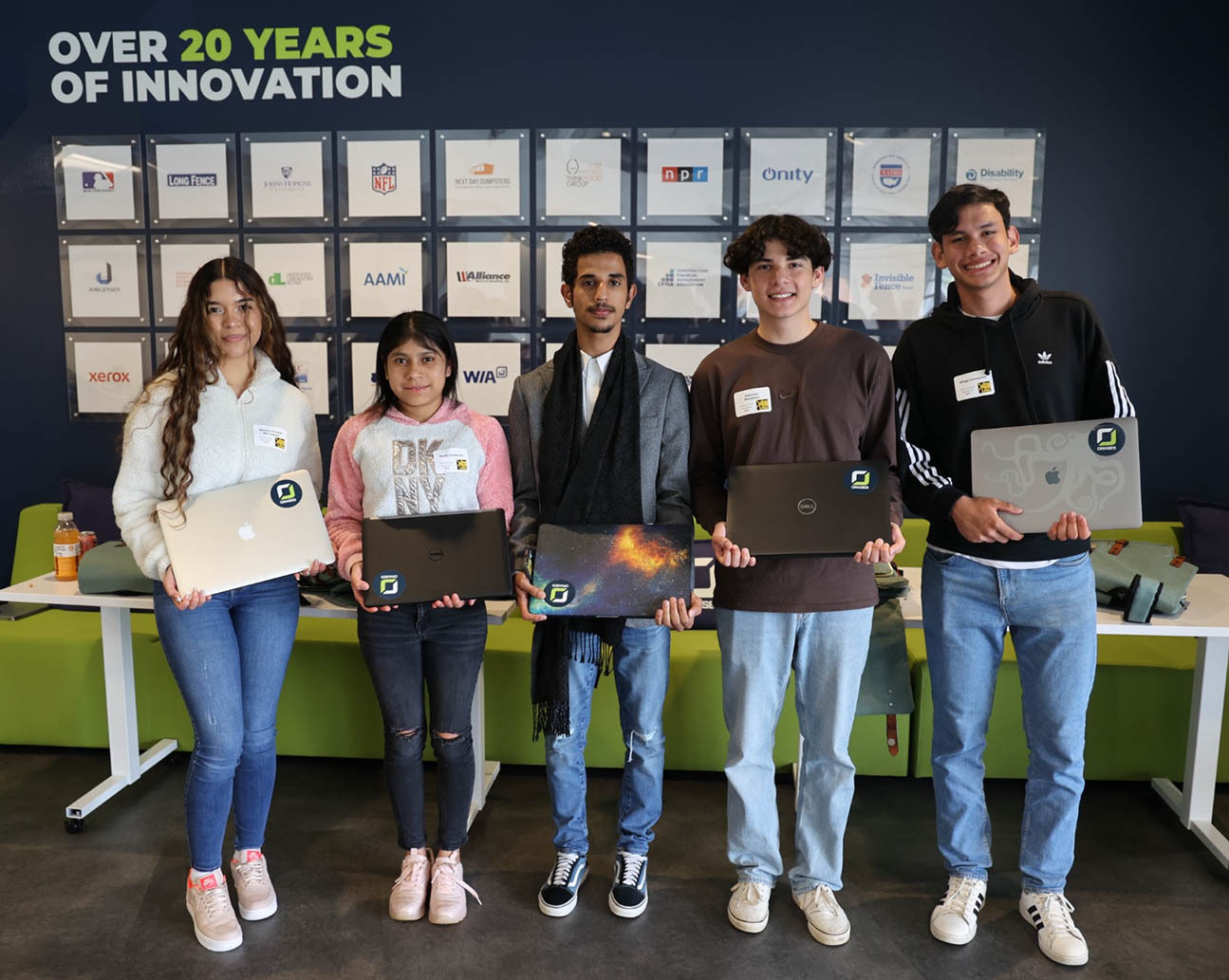 LYNX FHS Students smiling and holding laptops