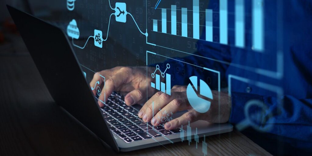 analyst working with business analytics and data management system on computer to make report