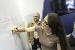 Orases team member working on the white board