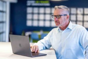 orases employee at desk working on data automation software