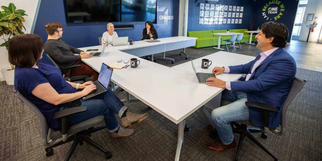 orases team members during group meeting