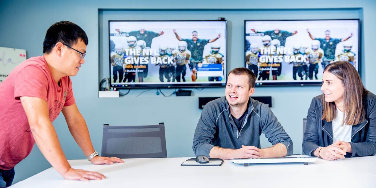 three members during an AI Email Assistant for Support Tickets presentation