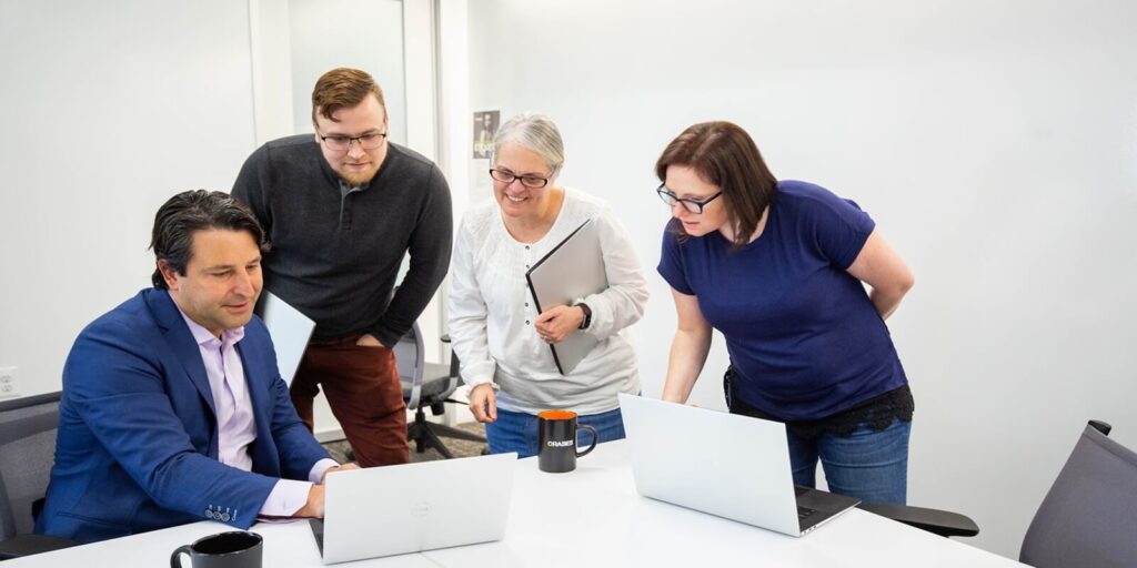 diverse team engaged in a productive discussion, sharing ideas and reviewing strategies together in a modern office setting